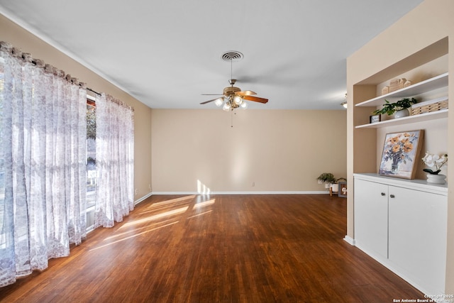 empty room featuring ceiling fan and dark hardwood / wood-style floors