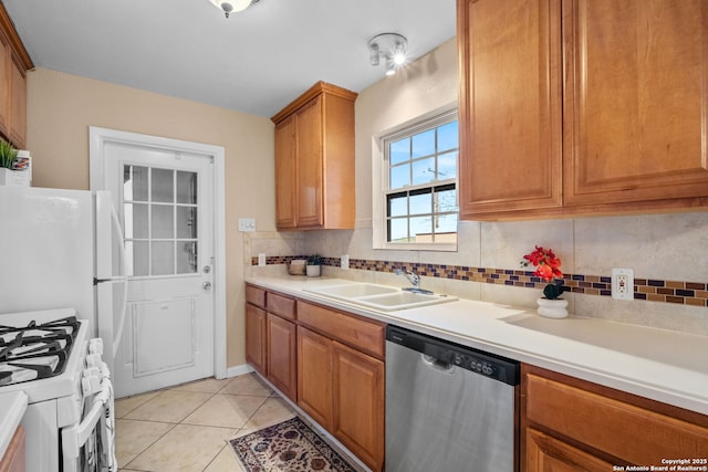 kitchen with white appliances, light tile patterned flooring, tasteful backsplash, and sink