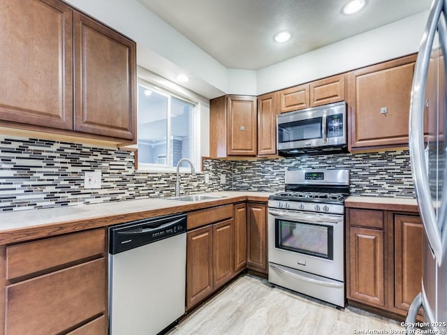 kitchen featuring sink, stainless steel appliances, and tasteful backsplash