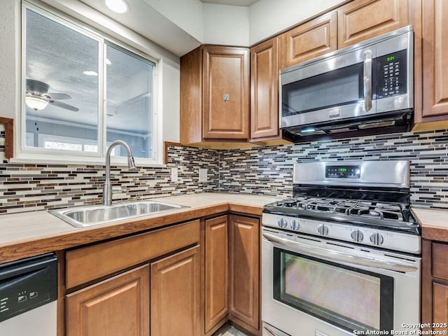 kitchen featuring sink, decorative backsplash, ceiling fan, and appliances with stainless steel finishes