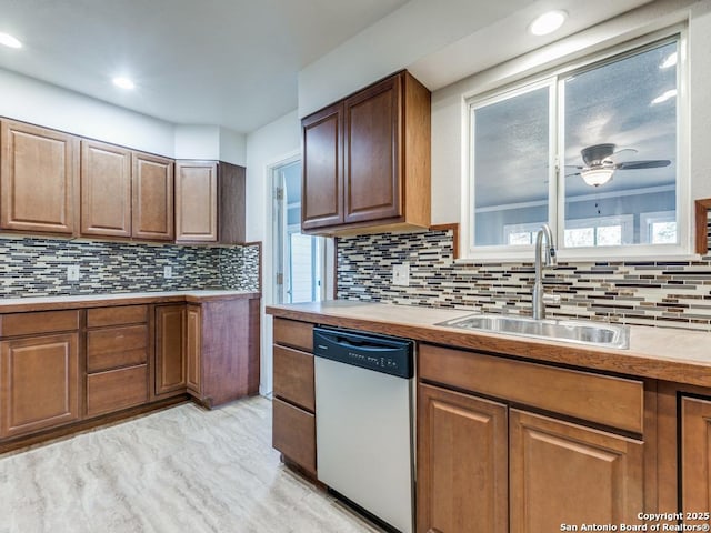 kitchen with light wood-type flooring, ceiling fan, dishwasher, and sink