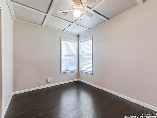 empty room with ceiling fan, coffered ceiling, and dark hardwood / wood-style floors