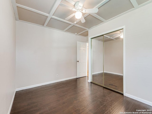 unfurnished bedroom featuring a closet, ceiling fan, and dark wood-type flooring