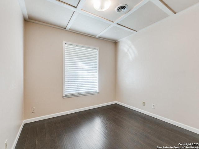 spare room with dark wood-type flooring and coffered ceiling