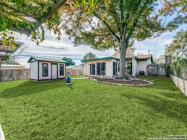 back of property featuring a yard, cooling unit, and an outdoor structure