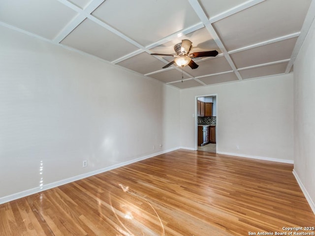 empty room with hardwood / wood-style floors, ceiling fan, and coffered ceiling