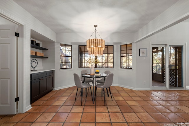 dining room featuring tile patterned flooring and a chandelier