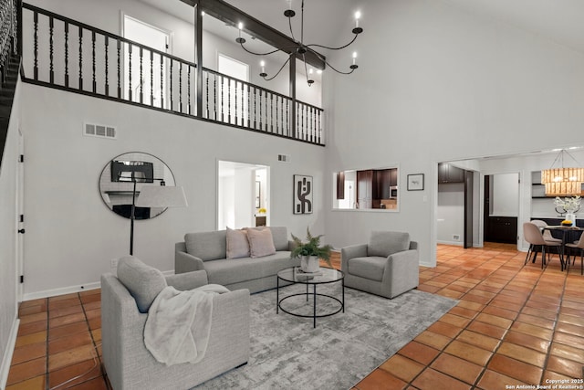 living room featuring a high ceiling, tile patterned flooring, and a chandelier