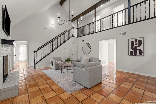 unfurnished living room with a towering ceiling, a brick fireplace, light tile patterned floors, and beamed ceiling