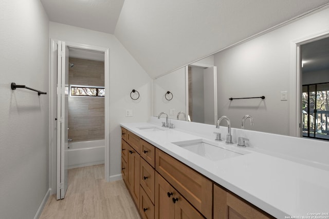 bathroom featuring vanity, hardwood / wood-style floors, and tiled shower / bath