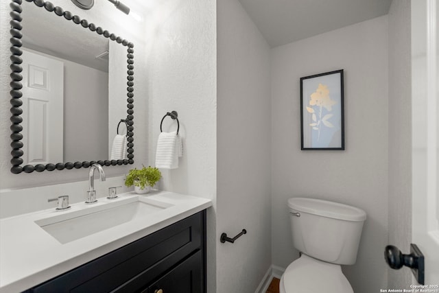 bathroom featuring toilet and vanity