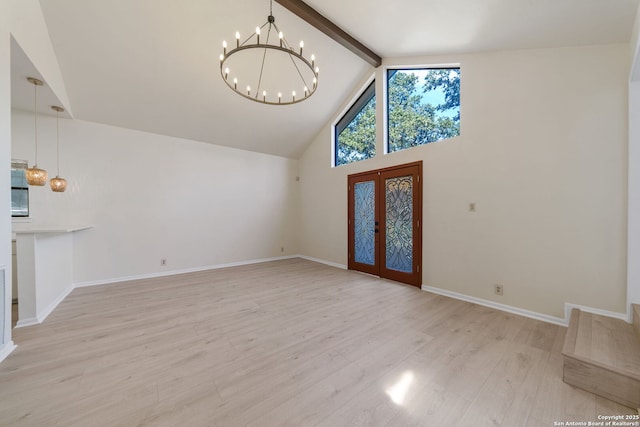 foyer featuring a chandelier, light hardwood / wood-style floors, french doors, high vaulted ceiling, and beam ceiling