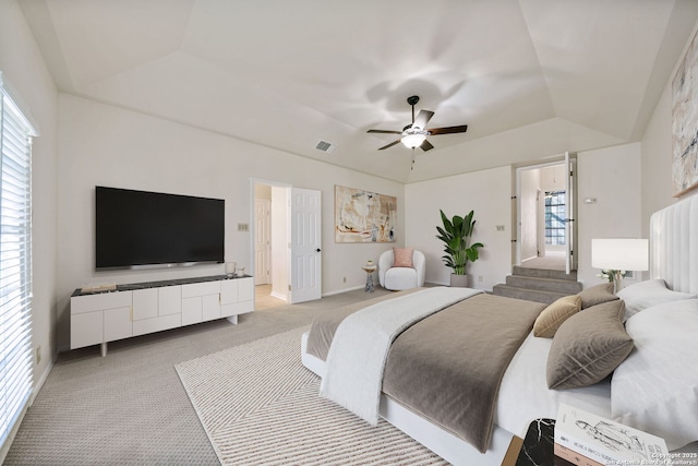 bedroom featuring ceiling fan, vaulted ceiling, and light colored carpet