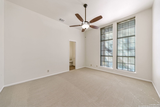 empty room featuring light carpet and ceiling fan