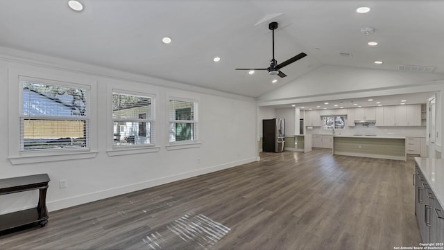 unfurnished living room with ceiling fan, ornamental molding, hardwood / wood-style flooring, sink, and lofted ceiling