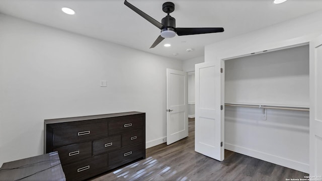 bedroom with ceiling fan and dark hardwood / wood-style flooring