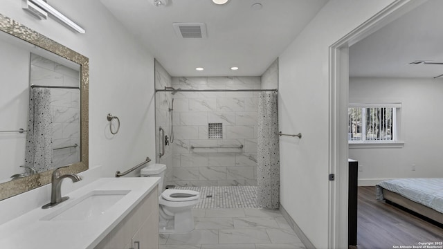 bathroom featuring toilet, walk in shower, and vanity