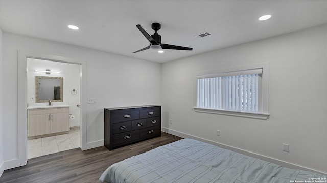 bedroom with sink, ensuite bathroom, wood-type flooring, and ceiling fan