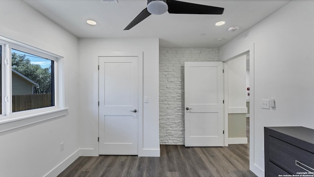 unfurnished bedroom featuring ceiling fan and dark hardwood / wood-style floors