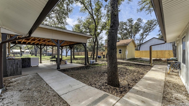 view of yard with a patio and a shed