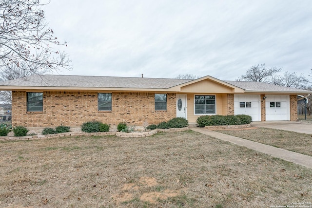 ranch-style home featuring a front lawn and a garage