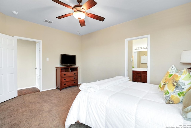 carpeted bedroom featuring ensuite bath and ceiling fan