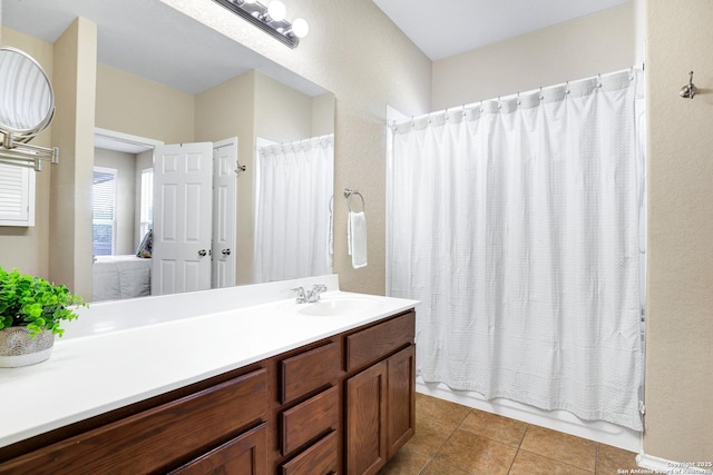 bathroom featuring tile patterned flooring, shower / tub combo with curtain, and vanity