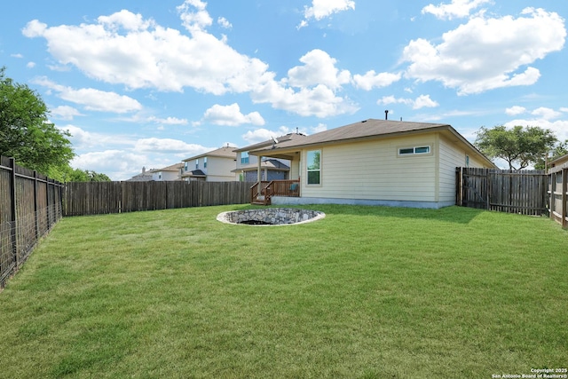 rear view of property featuring a lawn