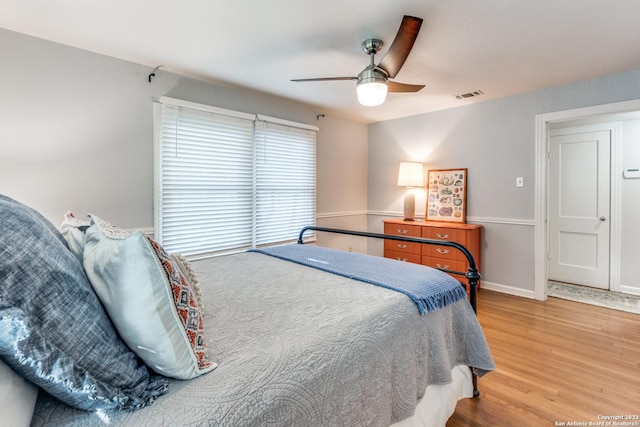 bedroom with ceiling fan and hardwood / wood-style flooring