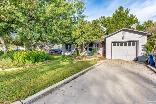 view of front of home featuring a front yard and a garage