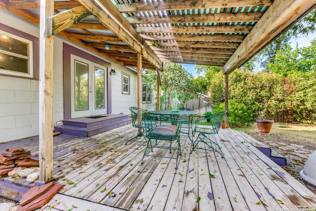 wooden terrace featuring french doors and a pergola