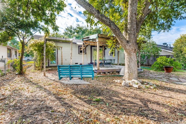 rear view of property with a wooden deck