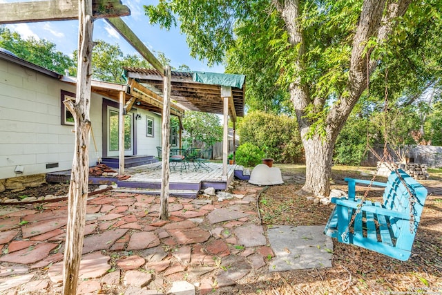 view of patio featuring a wooden deck and a pergola