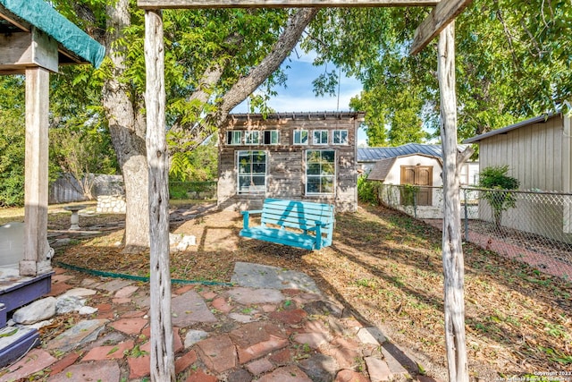 back of property with a patio area and a shed