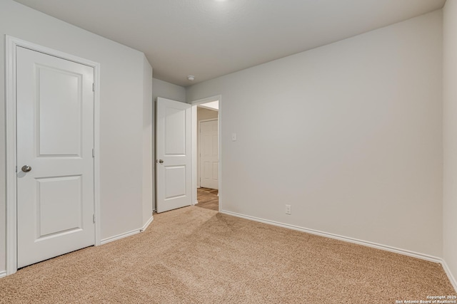 unfurnished bedroom featuring light colored carpet