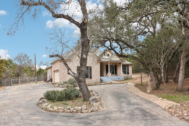 view of front of property with a garage, fence, aphalt driveway, and brick siding