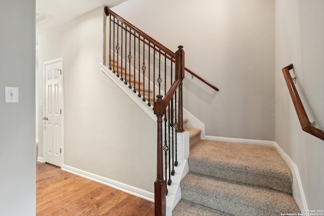 stairs with wood-type flooring