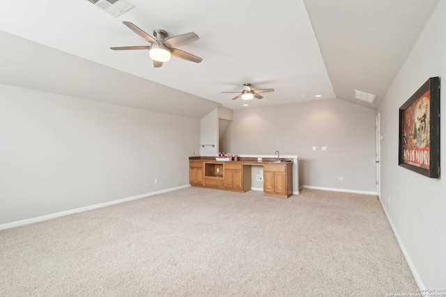 unfurnished living room featuring lofted ceiling, visible vents, light carpet, and baseboards