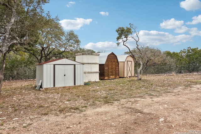 view of shed featuring fence