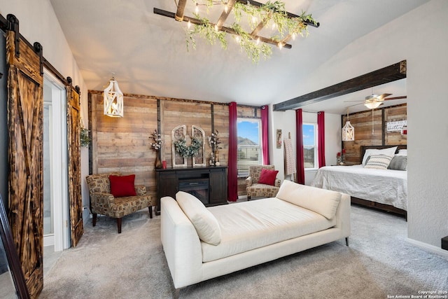 bedroom with ceiling fan, a barn door, light carpet, and wooden walls