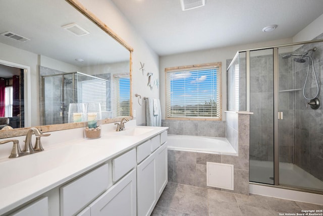 bathroom featuring vanity, plenty of natural light, and plus walk in shower