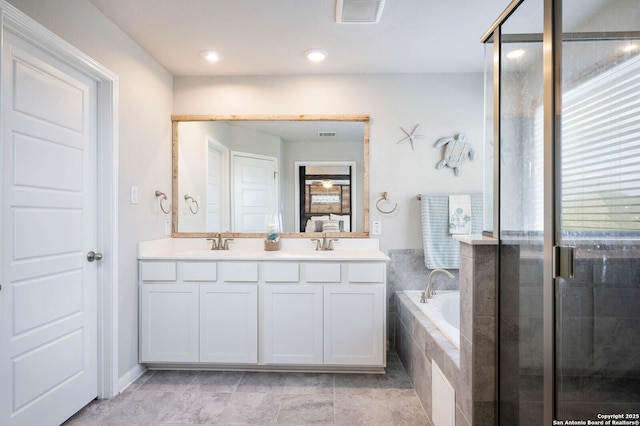 bathroom featuring vanity and shower with separate bathtub