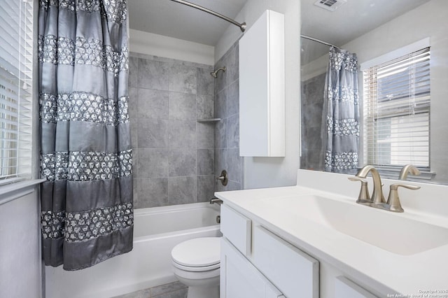 full bathroom featuring toilet, vanity, and shower / bath combo