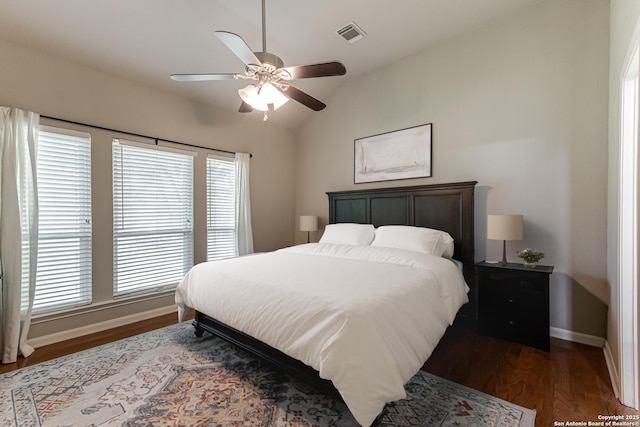 bedroom with ceiling fan, vaulted ceiling, and dark hardwood / wood-style floors