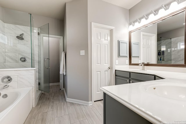 bathroom with independent shower and bath and vanity