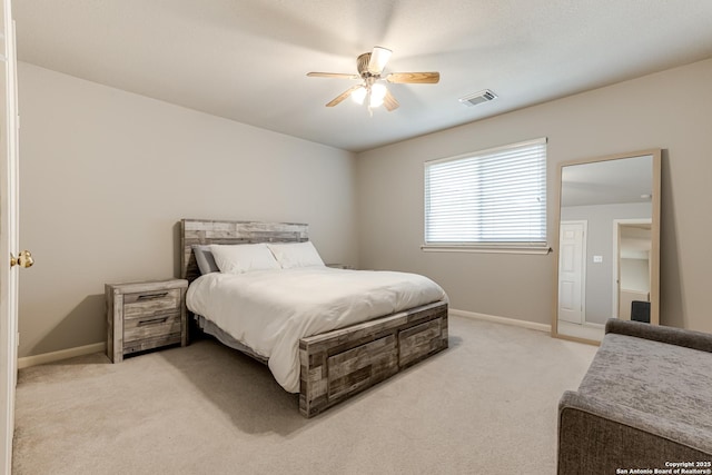 bedroom featuring ceiling fan and light colored carpet