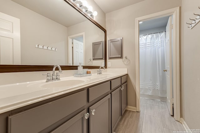 bathroom featuring a shower with shower curtain and vanity