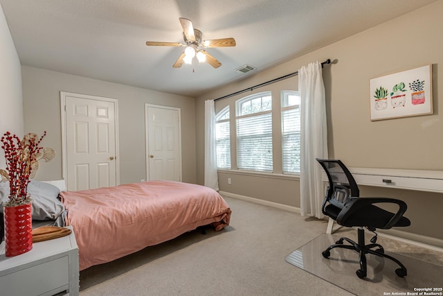 bedroom with light carpet and ceiling fan