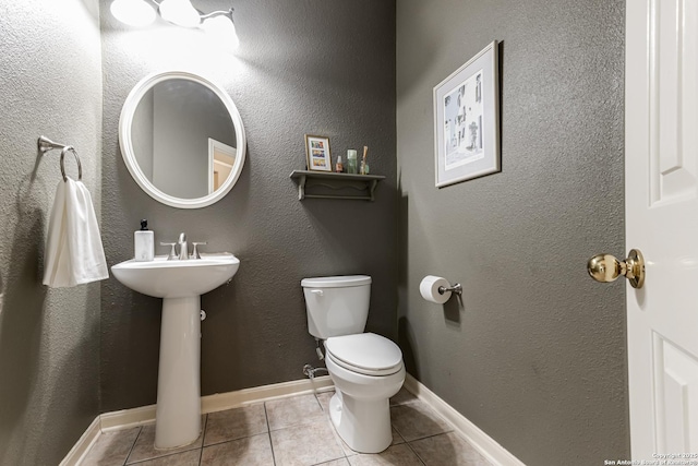 bathroom with tile patterned flooring and toilet