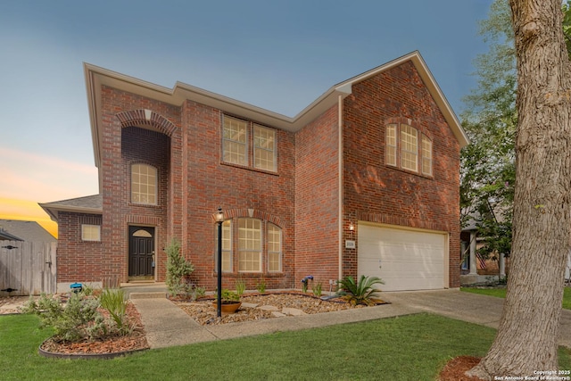 view of front facade featuring a garage and a lawn